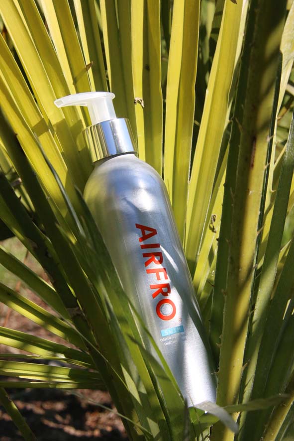 AirFro swim shampoo bottle in beach setting